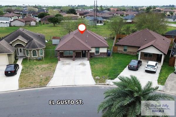 view of front of house with a residential view, driveway, and a front lawn