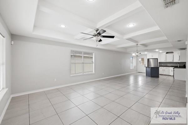 unfurnished living room featuring beam ceiling, visible vents, coffered ceiling, baseboards, and ceiling fan with notable chandelier