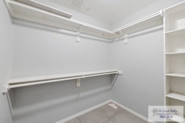 walk in closet with tile patterned floors