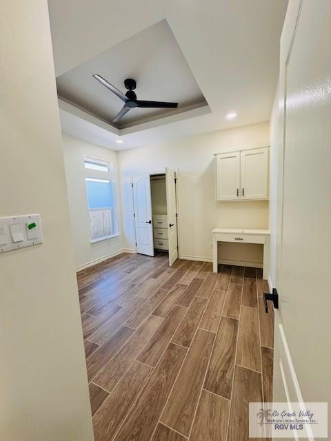 16602 Napper Ln, Primera, TX 78552 - spare room with a raised ceiling, dark wood-style flooring, a ceiling fan, baseboards, and recessed lighting