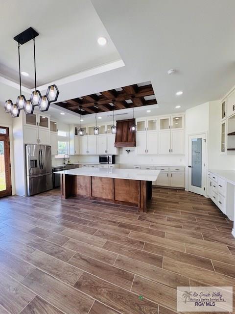 16602 Napper Ln, Primera, TX 78552 - kitchen featuring stainless steel appliances, a spacious island, a raised ceiling, light countertops, and recessed lighting