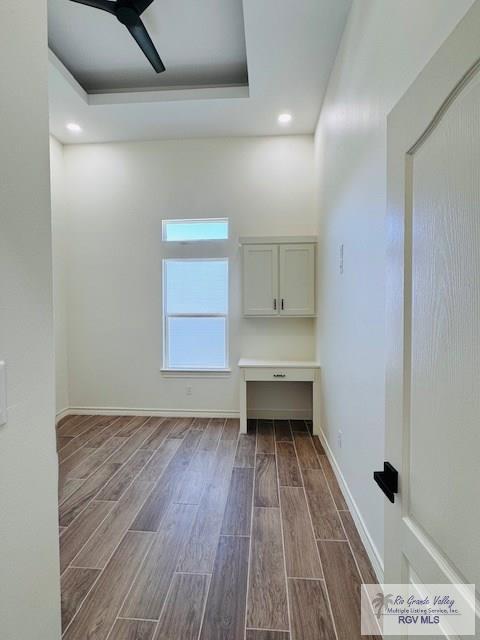 16602 Napper Ln, Primera, TX 78552 - spare room with dark wood-type flooring, ceiling fan, a tray ceiling, baseboards, and recessed lighting
