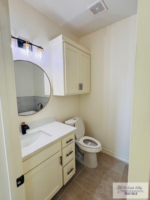 16602 Napper Ln, Primera, TX 78552 - bathroom with vanity, toilet, tile patterned flooring, and baseboards
