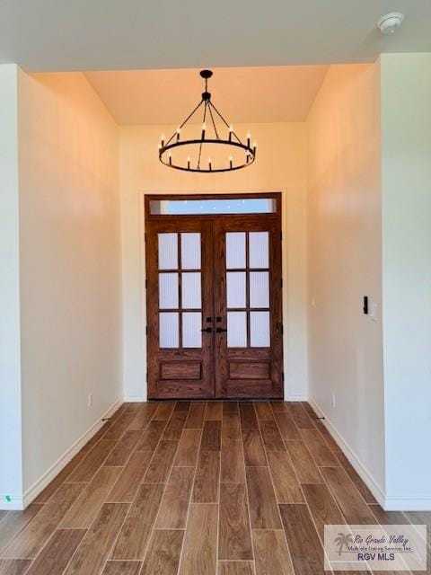 16602 Napper Ln, Primera, TX 78552 - foyer entrance featuring wood finished floors, baseboards, a chandelier, and french doors