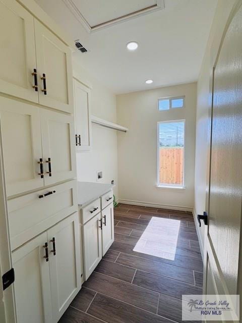 16602 Napper Ln, Primera, TX 78552 - laundry area with hookup for an electric dryer, cabinet space, recessed lighting, wood tiled floors, and baseboards