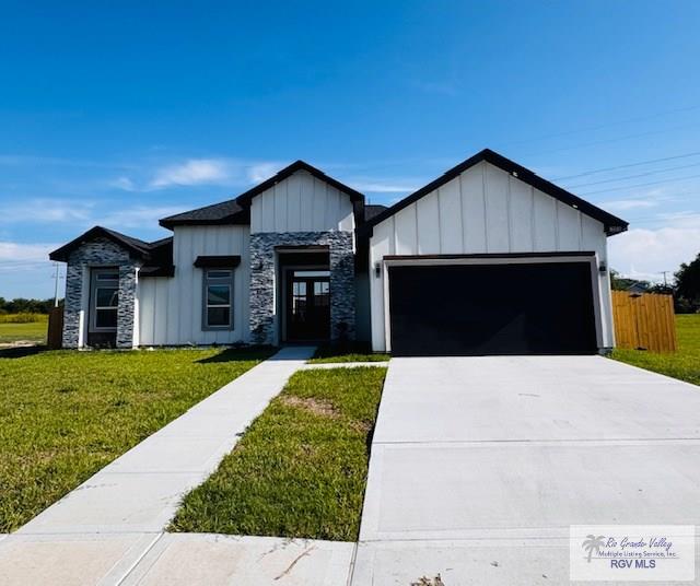 16602 Napper Ln, Primera, TX 78552 - modern inspired farmhouse with board and batten siding, an attached garage, concrete driveway, and stone siding