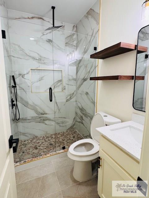 16602 Napper Ln, Primera, TX 78552 - full bathroom featuring vanity, a marble finish shower, and toilet