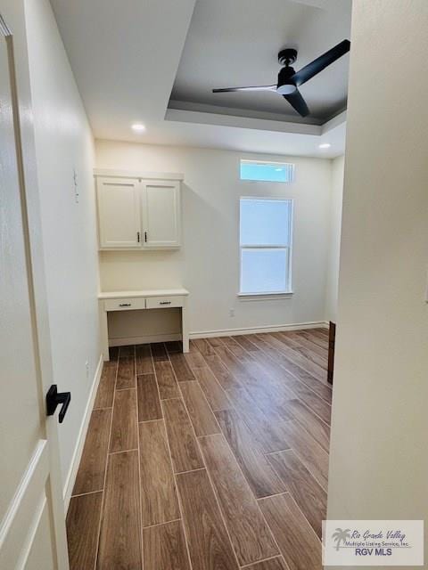 16602 Napper Ln, Primera, TX 78552 - spare room featuring dark wood-type flooring, a raised ceiling, baseboards, a ceiling fan, and recessed lighting