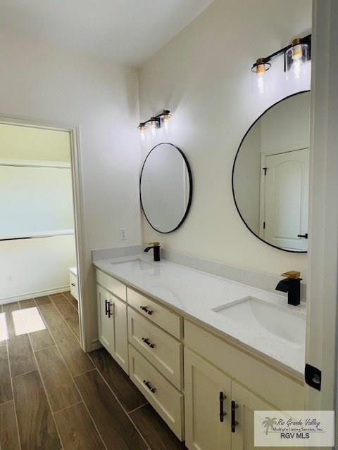 16602 Napper Ln, Primera, TX 78552 - bathroom featuring double vanity and wood tiled floors