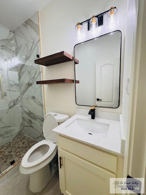 16602 Napper Ln, Primera, TX 78552 - bathroom featuring vanity, a marble finish shower, and toilet