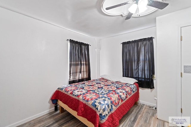 bedroom with hardwood / wood-style flooring and ceiling fan