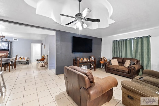 tiled living room featuring ceiling fan