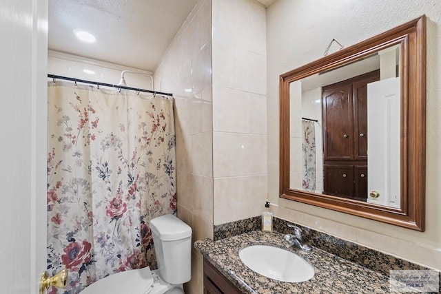 bathroom featuring vanity, a shower with shower curtain, and toilet