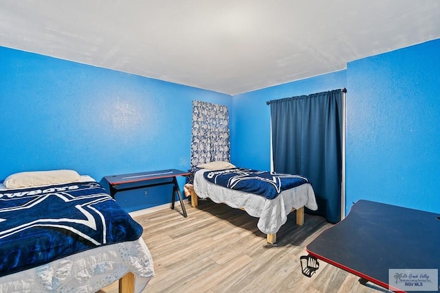 bedroom with hardwood / wood-style flooring