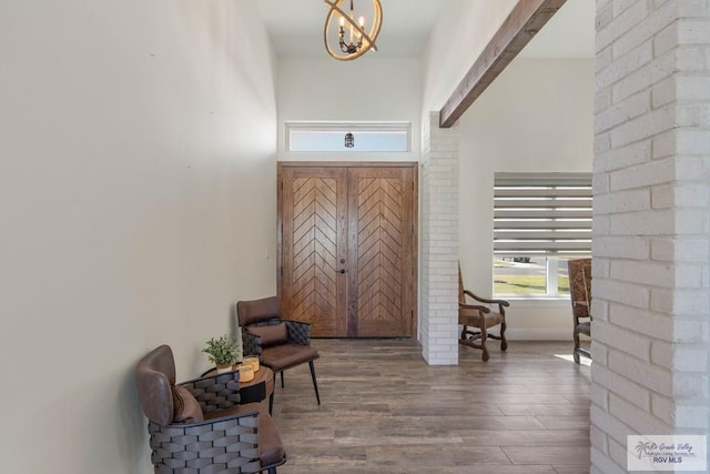 foyer entrance featuring a chandelier and hardwood / wood-style flooring