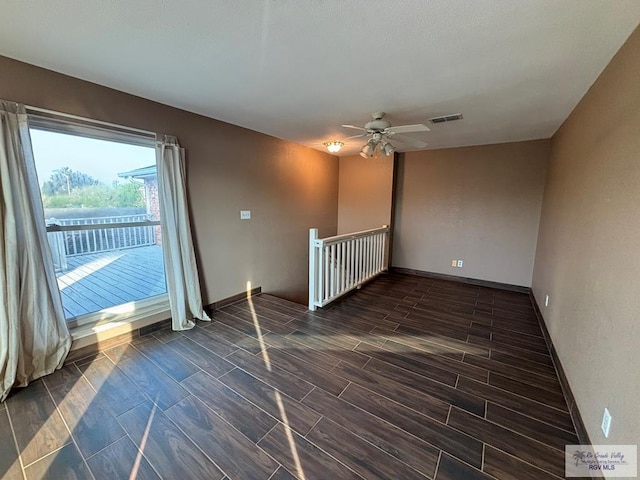 1060 Timothy St, San Benito, TX 78586 - empty room with baseboards, a ceiling fan, visible vents, and wood tiled floor
