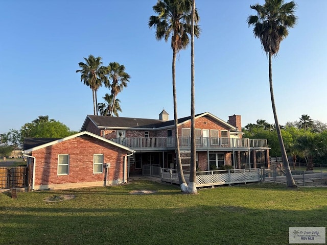 1060 Timothy St, San Benito, TX 78586 - rear view of property with brick siding, a lawn, and fence