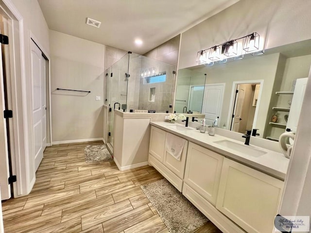3706 Bea Ave, Harlingen, TX 78552 - bathroom with a shower stall, wood finished floors, double vanity, and baseboards