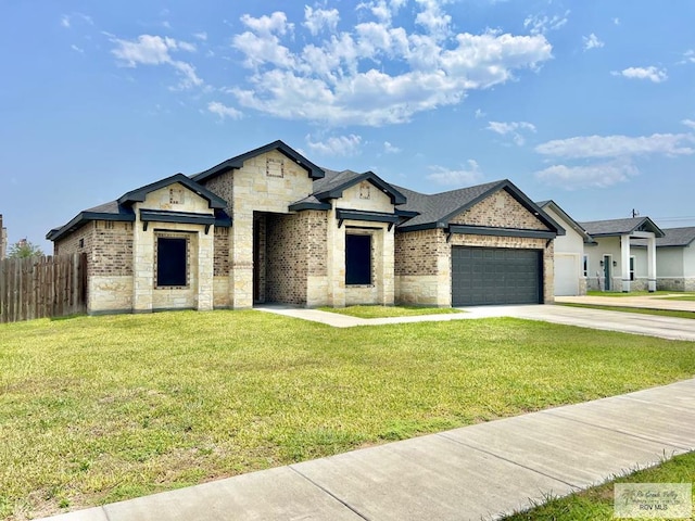 3706 Bea Ave, Harlingen, TX 78552 - french provincial home featuring stone siding, an attached garage, concrete driveway, and brick siding