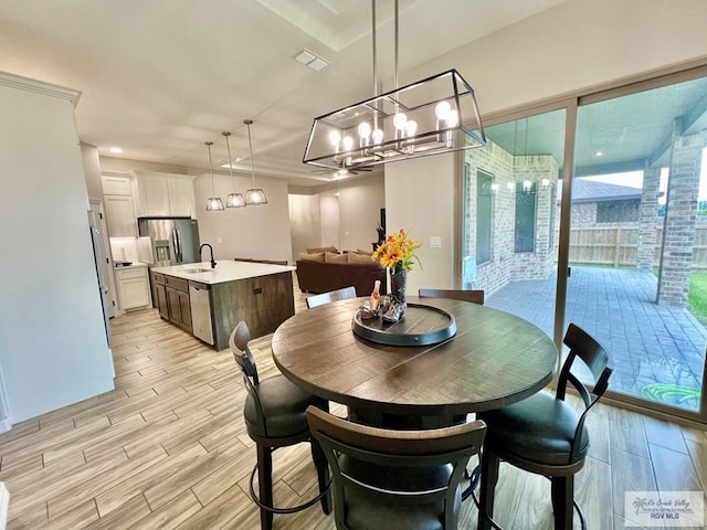 3706 Bea Ave, Harlingen, TX 78552 - dining room with wood tiled floors and a chandelier