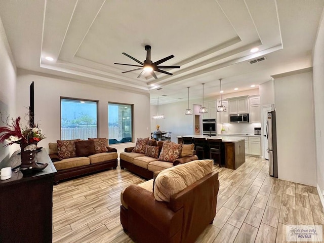 3706 Bea Ave, Harlingen, TX 78552 - living room with a raised ceiling, a ceiling fan, wood tiled floors, and recessed lighting