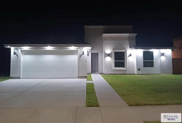 view of front of house with a lawn and a garage