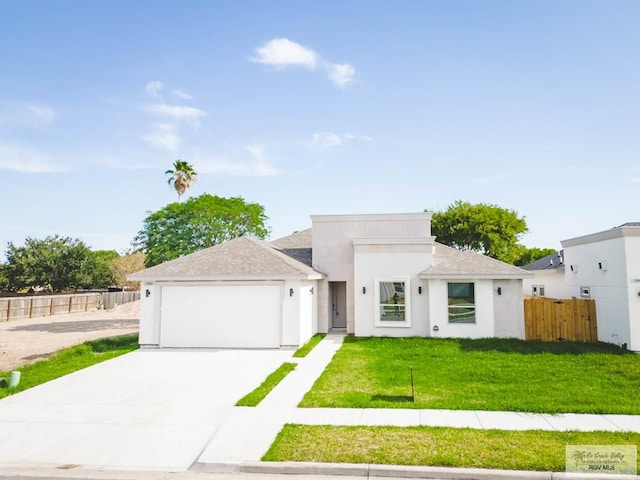 view of front of house featuring a front yard and a garage