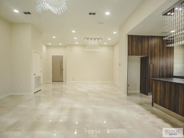 unfurnished living room with a chandelier