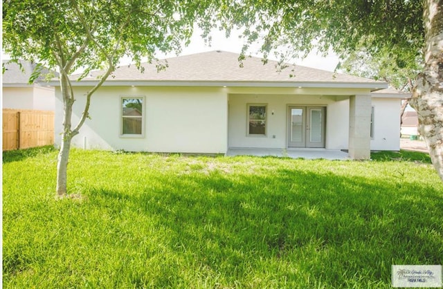 back of property featuring a lawn