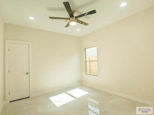 tiled empty room featuring ceiling fan