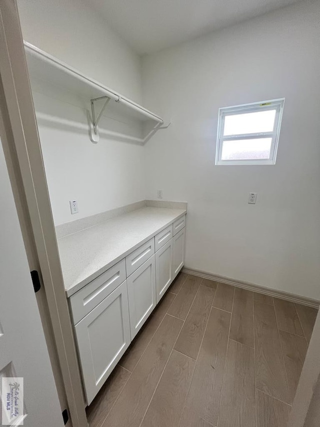 clothes washing area featuring light hardwood / wood-style flooring