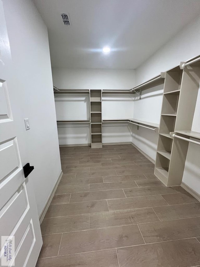 spacious closet with wood-type flooring