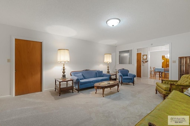 living room with carpet flooring and a textured ceiling