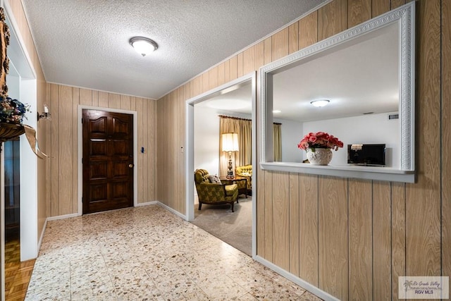 7969 Fm 2099, Lyford, TX 78580 - entrance foyer featuring wooden walls and a textured ceiling