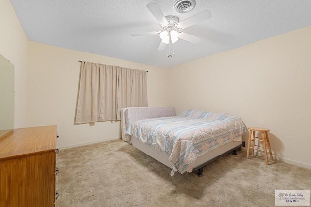 bedroom with baseboards, visible vents, ceiling fan, a textured ceiling, and carpet flooring