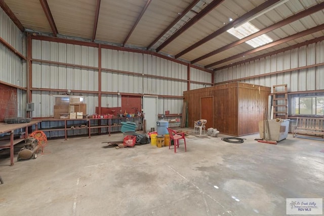 garage with a workshop area and metal wall