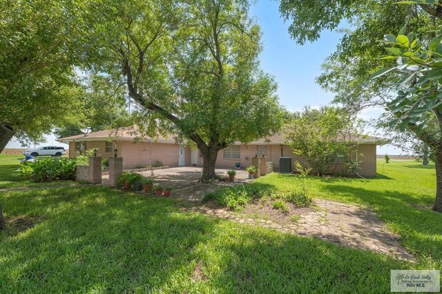 7969 Fm 2099, Lyford, TX 78580 - view of green lawn with central air condition unit