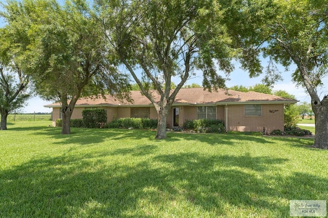 view of front of house featuring a front yard and brick siding