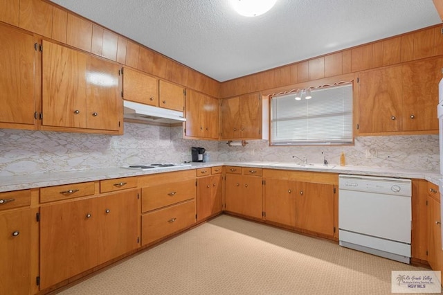 kitchen with white appliances, light floors, a sink, light countertops, and under cabinet range hood