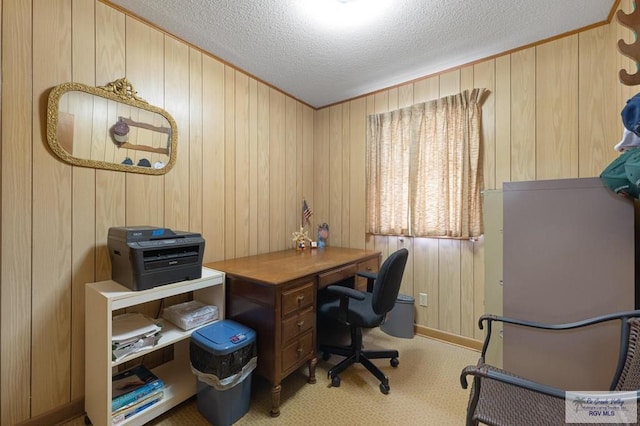 carpeted home office with a textured ceiling and wooden walls