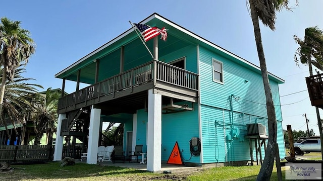 rear view of house with a lawn and a patio area