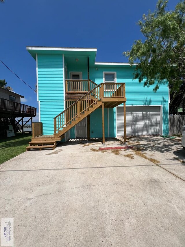 back of house featuring a wooden deck