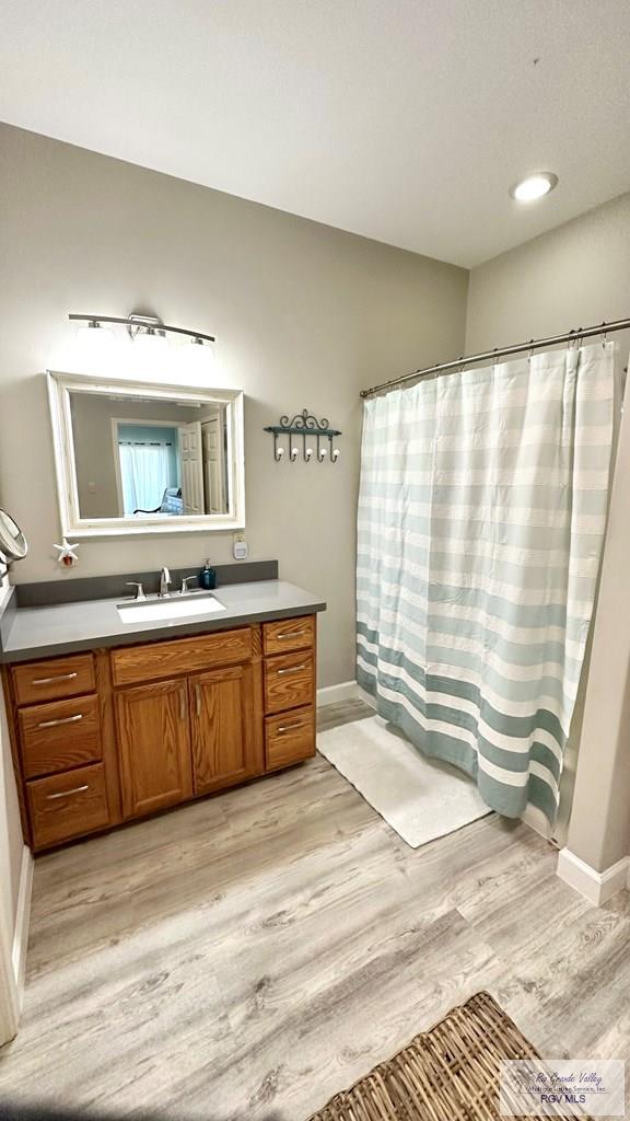 bathroom with vanity and wood-type flooring