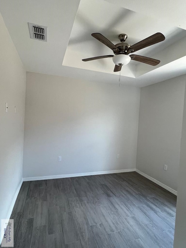 spare room featuring dark hardwood / wood-style floors and ceiling fan