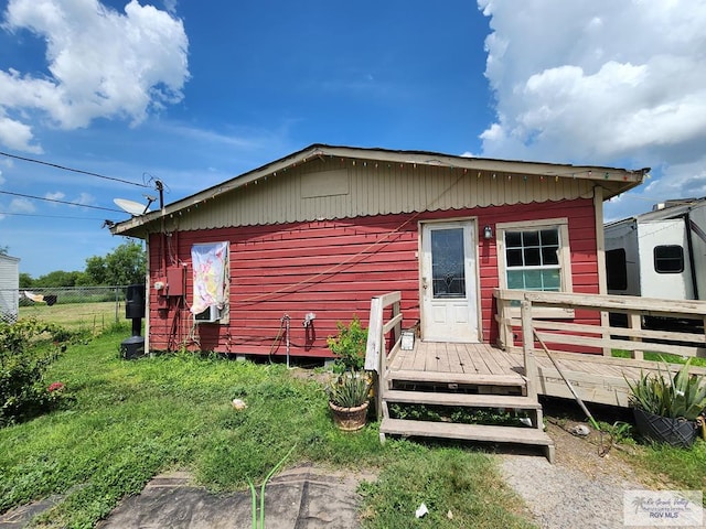 rear view of property featuring a deck