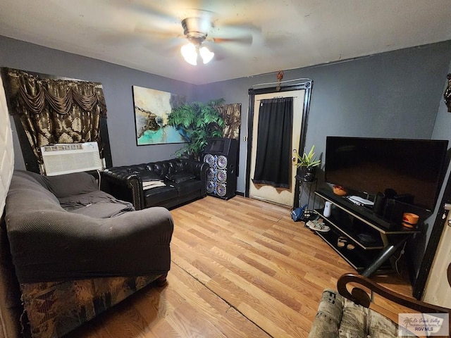 living room featuring ceiling fan, cooling unit, and hardwood / wood-style flooring