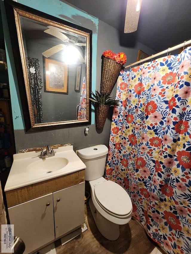 bathroom featuring hardwood / wood-style floors, vanity, toilet, and ceiling fan