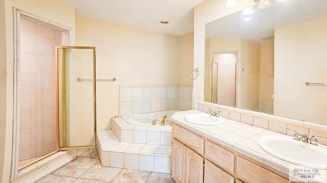 bathroom with tile patterned flooring, shower with separate bathtub, and vanity