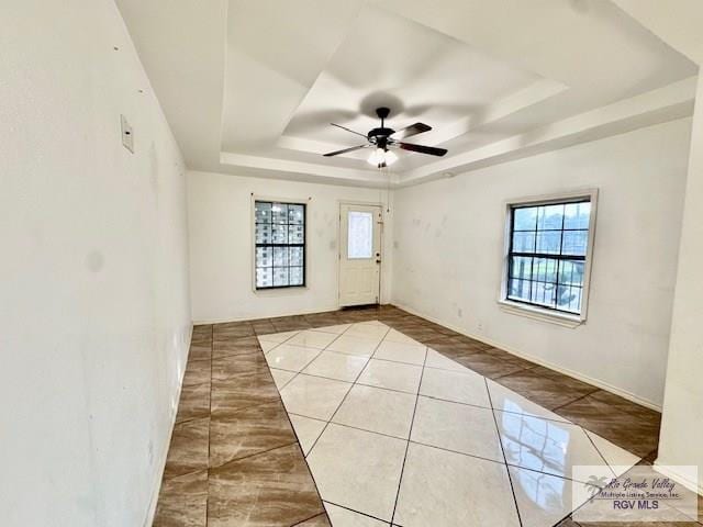 2413 Eastern Blvd, Brownsville, TX 78520 - spare room featuring a raised ceiling, tile patterned flooring, ceiling fan, and baseboards