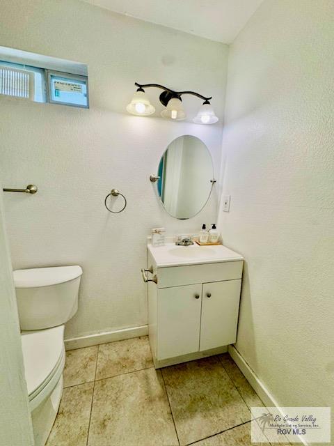 2413 Eastern Blvd, Brownsville, TX 78520 - bathroom featuring vanity, toilet, tile patterned floors, and baseboards